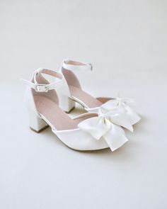 This flower girls block heels adorn with a charming satin bow detail on the vamp adds a touch of an elegance and grace for little princess for birthday party, holiday party, wedding party, flower girls, quinceanera shoes, and other special occasions.DETAILS:HEEL HEIGHT: 2 inchesCOLORS AVAILABLE: White and IvoryUPPER: Synthetic upper and liningMATERIALS: Manmade outsole Cute Graduation Shoes, Grad Shoes, High Heels For Kids, Quinceanera Shoes, Graduation Shoes, Kids Heels, Fancy Heels, Cute High Heels, Girls Heels