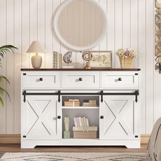 a white dresser with open doors and drawers in front of a round mirror on the wall