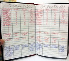 a hand holding an open planner with dates and times on the page in front of it