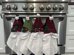 three christmas stockings hanging from the oven