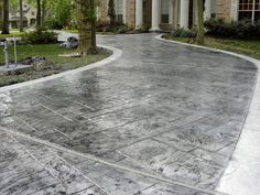 a driveway that has been cleaned and is surrounded by trees