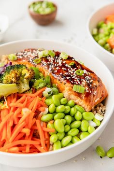 healthy salmon teriyaki bowls with carrots, broccoli and peas