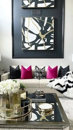 a living room filled with lots of furniture next to a painting on the wall above a coffee table