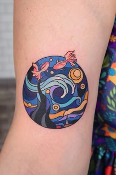 a woman's arm with a colorful tattoo design on the left side of her body