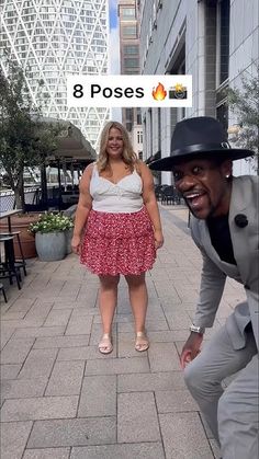 a man and woman are standing on the sidewalk