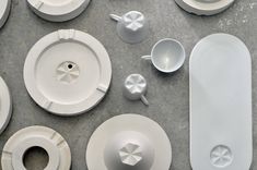 white dishes and cups are laid out on the floor