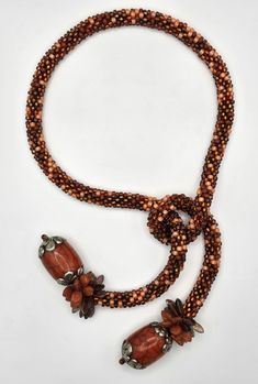 Beaded Necklace - A mixture of hundreds of orange glass seed beads are crocheted into this tweed-look rope.  It ends in two silver-capped bone beads from Bhutan, surrounded by a fringe of Czech glass leaves and daggers.  Shorter in length, it is easy-to-wear. Crochet Rope, Silver Caps, Artful Home, Bone Beads, Crochet Dog, Bhutan, Glass Seed Beads, Beading Patterns, Czech Glass