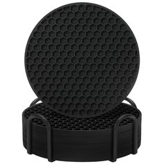 a black round device holder with holes in the center and two handles on each side