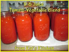 six jars filled with tomato sauce sitting on top of a counter