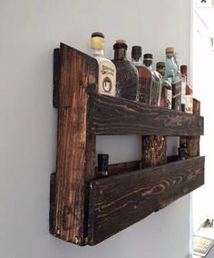 a wooden shelf with bottles on top of it