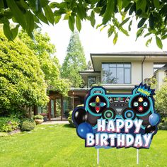 a happy birthday yard sign in front of a house with a video game controller on it