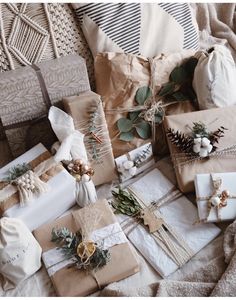 presents wrapped in brown paper and tied with twine on top of a bed covered in blankets