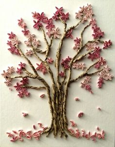 a tree made out of branches with pink flowers on the top and bottom part of it