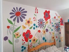 a bedroom with flowers painted on the wall