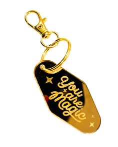 a black and gold keychain with the words, we are happy on it