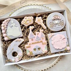 a box filled with decorated cookies on top of a table