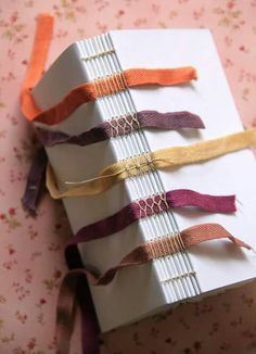 a stack of wrapped books with ribbons on them