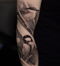 a woman's arm with two birds on it