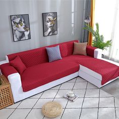 a red and white couch sitting on top of a tiled floor