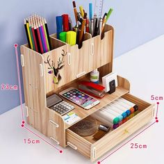 the wooden desk organizer is organized with pens, pencils and markers