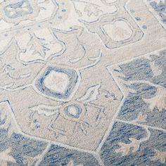 an area rug with blue and white designs on the ground, including stars and circles