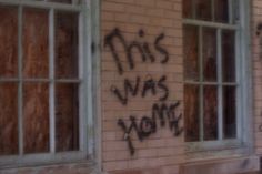 graffiti is spray painted on the side of an old brick building that has been vandalized