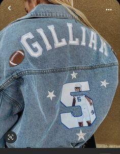 a woman wearing a jean jacket with the number 5 on it and a football painted on her back