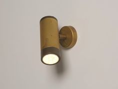 a light that is on the side of a white wall with no one in it