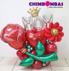 the balloon bouquet is made up of red and green balloons, flowers, and hearts