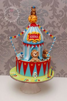 a circus themed cake with animals on top