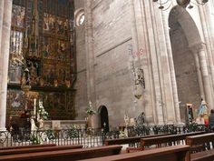 the interior of an old church with pews