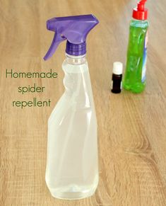 a purple spray bottle sitting on top of a wooden table