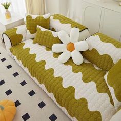 a green and white couch with flowers on it