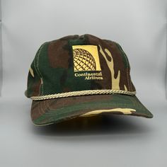 Vintage '80s/'90s Continental Airlines (United) Camo Rope Hat Perfect Unused, Unworn, Deadstock Condition Features The Continental Airlines Logo Embroidered On The Front (Now United Airlines) With A Plastic Strapback And Brass Enclosure. Nice Thick Material. Standard Disclaimer: As With Any Used Or Vintage Hat, The Original Materials May Be In Lesser Condition Than A Brand New Piece. Extra Care Has Been Taken To Ensure This Purchase Is Not Only Wearable, But Enjoyable, Too. Please Be Mindful Of Another Lifetime, Airlines Logo, Continental Airlines, Airline Logo, The Continental, Camo Hats, United Airlines, Now United, Vintage Hat