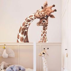 two giraffes standing next to each other in a bedroom