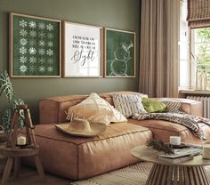 a living room filled with furniture and pictures hanging on the wall above a coffee table