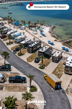 an aerial view of a parking lot with rvs parked on the beach and palm trees