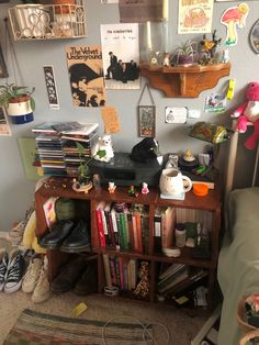 a cluttered room with many books and pictures on the wall