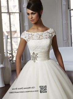 a woman in a wedding dress posing for the camera