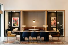 a dining room table and chairs in front of a large window