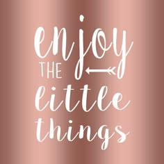 the words enjoy the little things are written in white ink on a copper metallic background