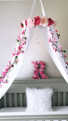 a white bed with pink flowers on it