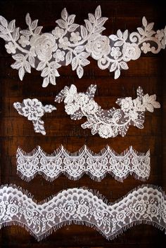 several white lace trims on a wooden surface