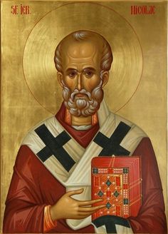 an icon of st nicholas the great holding a red book with gold trimmings