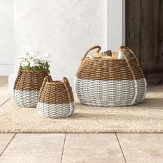 two woven baskets sitting on top of a rug