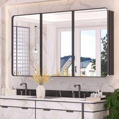 a bathroom with marble counter tops and large mirrors on the wall, along with two sinks