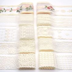 several pieces of white crochet lace with pink flowers on the edge and two rows of them