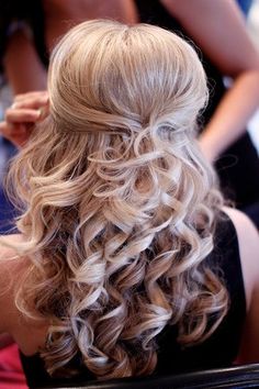 the back of a woman's head with long curly hair and curls on it