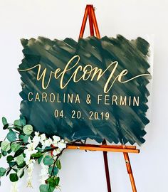 a welcome sign on top of a easel