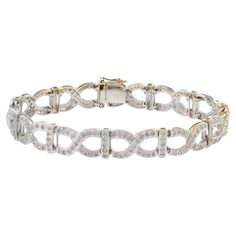 This estate 18KT white gold X link bracelet boasts an impressive 2.52CT-TW of sparkling diamonds, making it a luxurious and eye-catching accessory. Crafted with high-quality materials, it is a timeless investment piece that will elevate any outfit. With its elegant design and stunning diamond embellishments, this bracelet is sure to make a statement and leave a lasting impression. Gold Globe, Retro Bracelet, Ruby Bracelet, Gold Link Bracelet, Stunning Earrings, Vintage Bracelets, Oval Diamond, Sparkle Diamonds, Diamond Stone